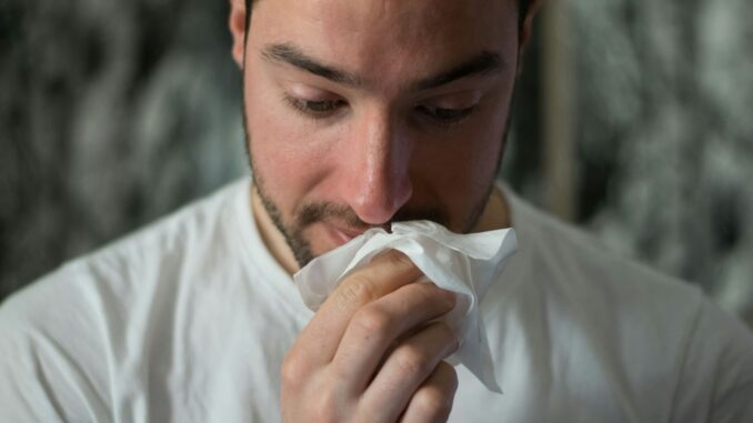 Photo by Brittany Colette man wiping mouse with tissue paper