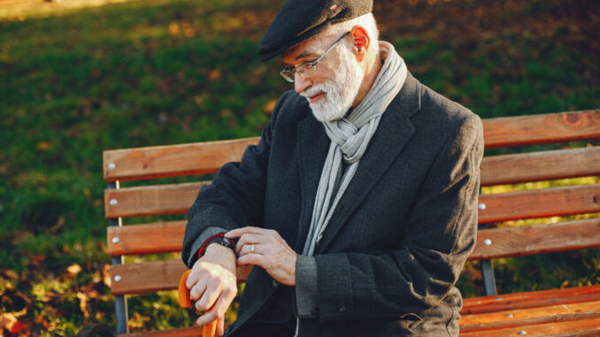 Elegant old man in a sunny autumn park
