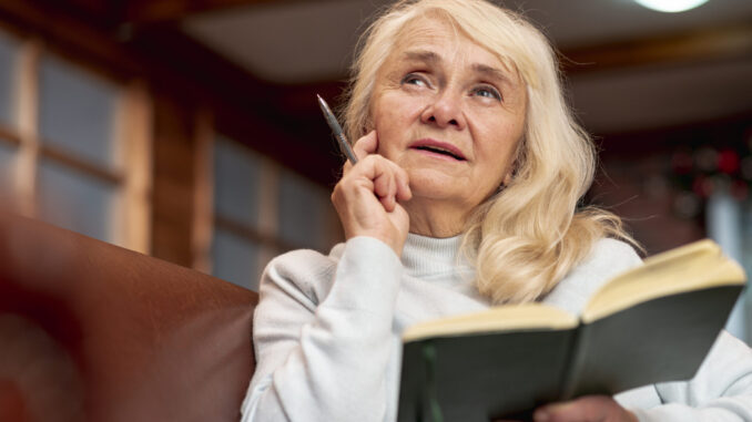 low-angle-elder-woman-holding-agenda