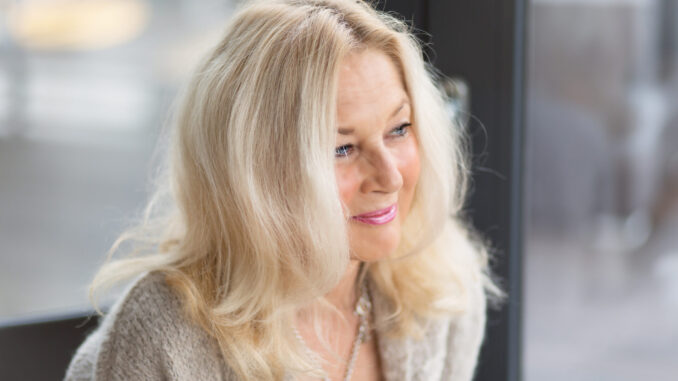 close-up-mature-blond-woman-looking-away-while-smiling
