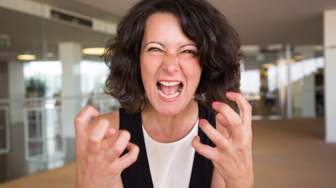 Crazy furious woman shouting at camera