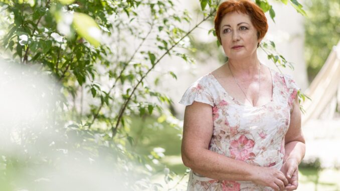 redhead-woman-floral-dress-looking-away