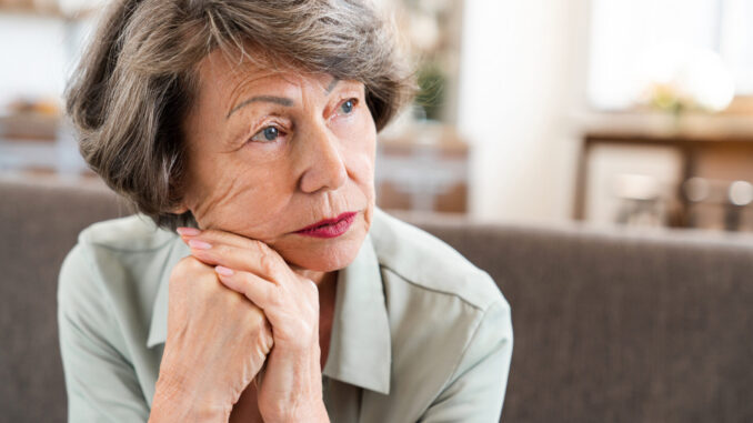 Sad tired exhausted caucasian old woman thinking about future past having nostalgy grief