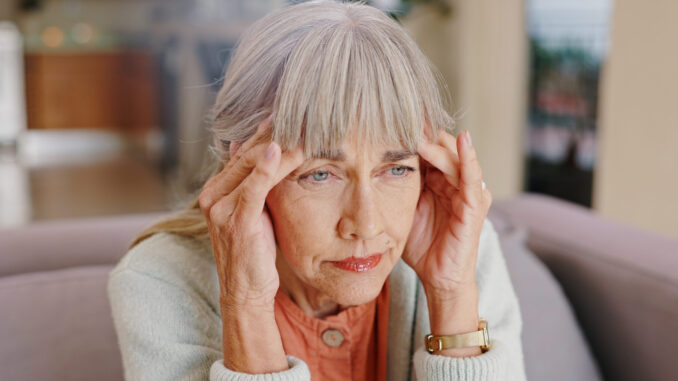 senior-woman-thinking-depressed-lounge-hand-memory-past-retirement-sad-nursing-home-grandma-lonely-couch-house-remember-elderly-person-living-room-grief