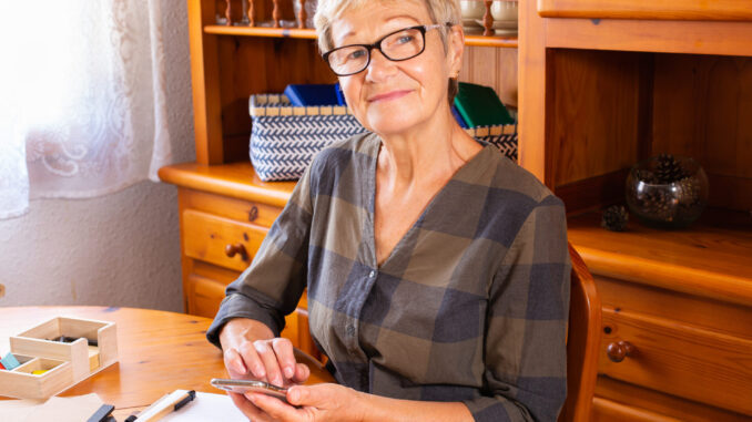 Senior woman using phone, making video call