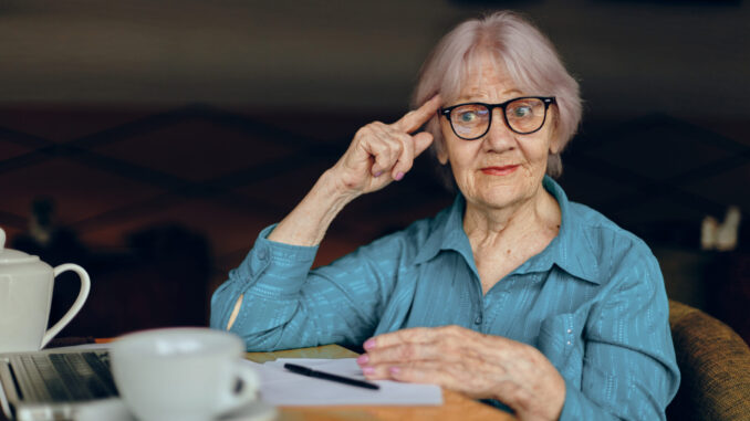 elderly woman documents work sheet of paper and pen Lifestyle unaltered