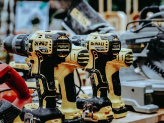 yellow Dewalt hand drills on table