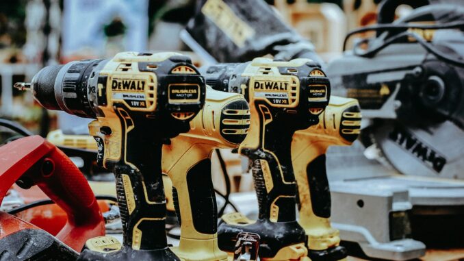 yellow Dewalt hand drills on table